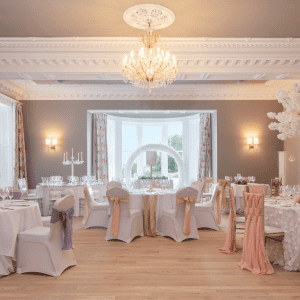 Elegant hotel banquet hall with luxurious decor and chandelier lighting.