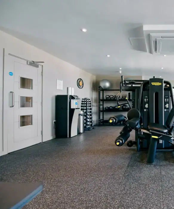 Modern hotel gym with fitness equipment and workout space at The Ro Hotel, perfect for active guests.