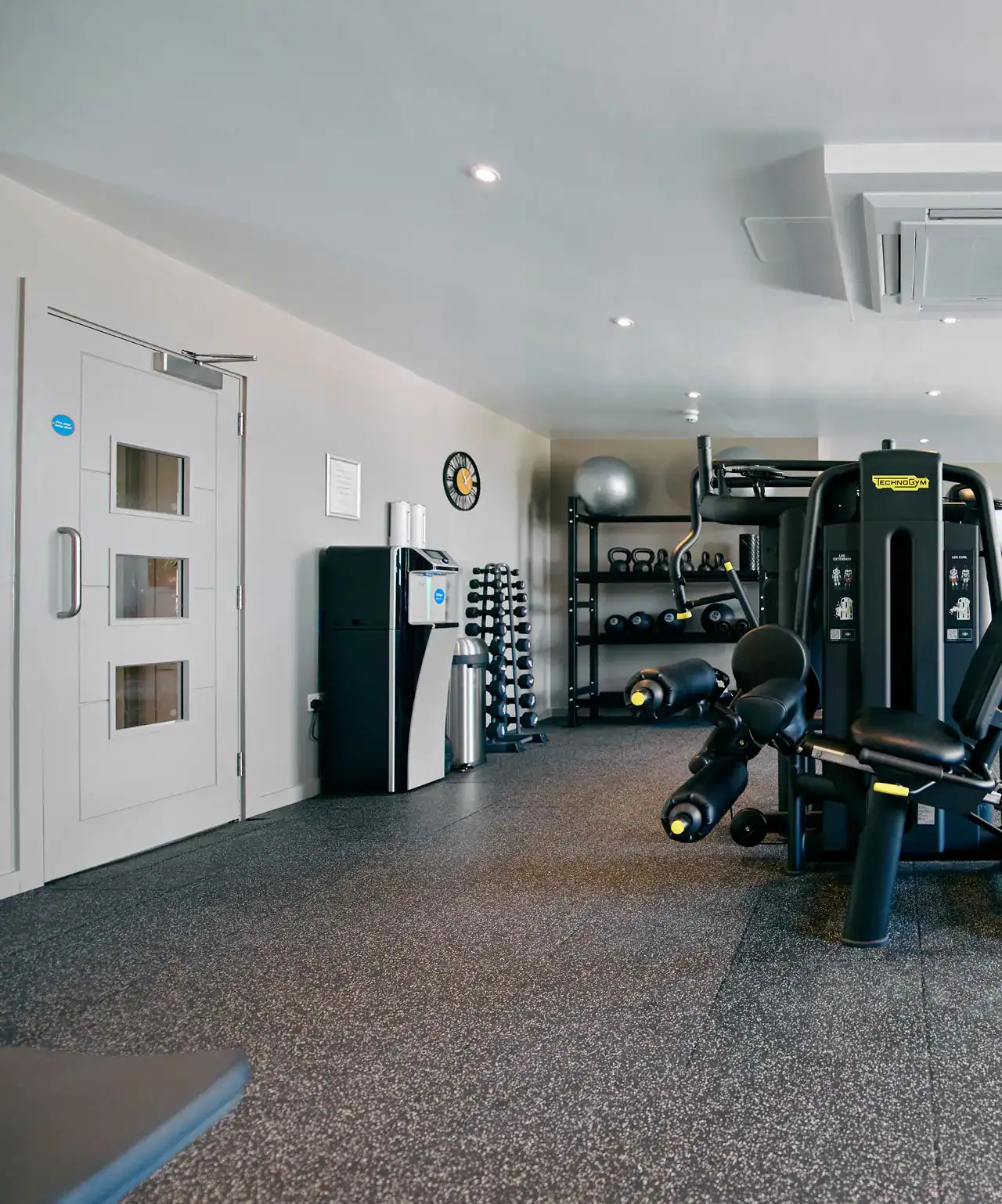 Modern hotel gym with fitness equipment and workout space at The Ro Hotel, perfect for active guests.