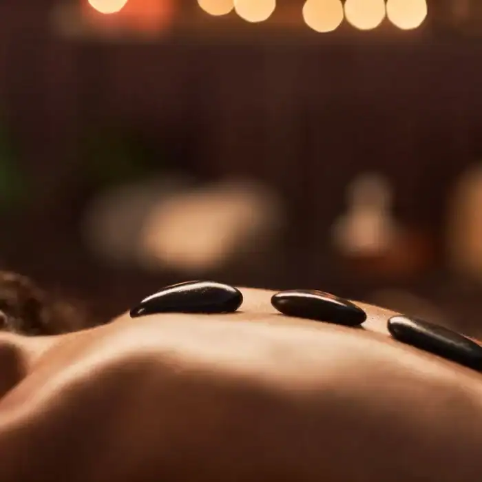 Relaxing hot stone massage therapy at The Ro Hotel spa.