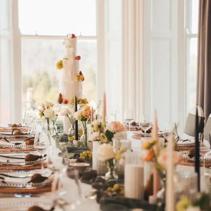 Elegant event setup with floral arrangements and fine dining at The Ro Hotel.