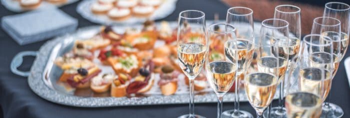 Elegant hotel event with champagne glasses and gourmet appetizers at The Ro Hotel, perfect for luxury gatherings.