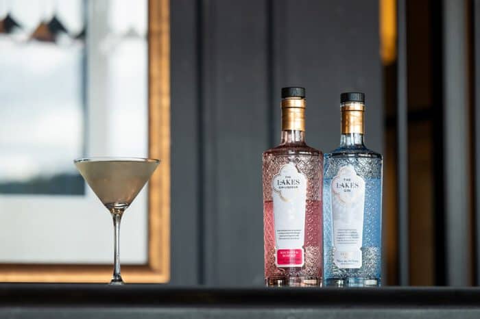 Elegant gin bottles and cocktail glass at The Ro Hotel bar, perfect for leisure and couples' getaways.