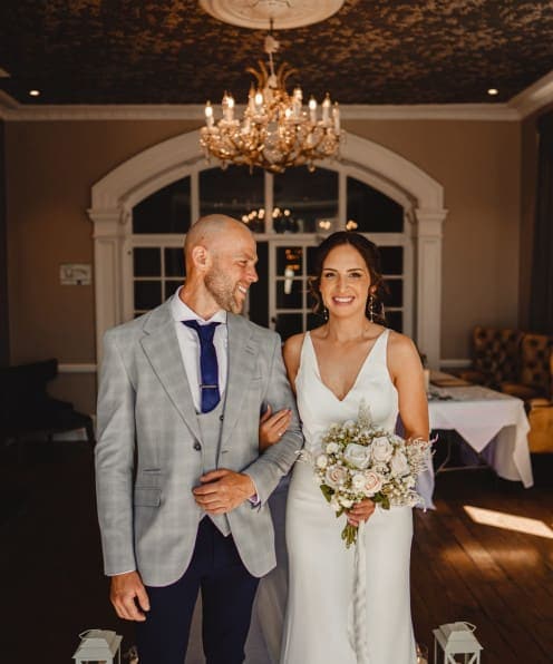 Elegant wedding at The Ro Hotel with bride and father, luxurious interior, chandeliers, and romantic atmosphere in timeless venue.