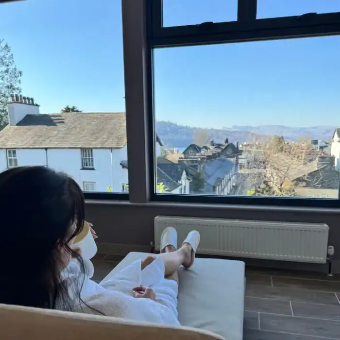 Stylish hotel room with panoramic city views at The Ro Hotel, perfect for relaxation.