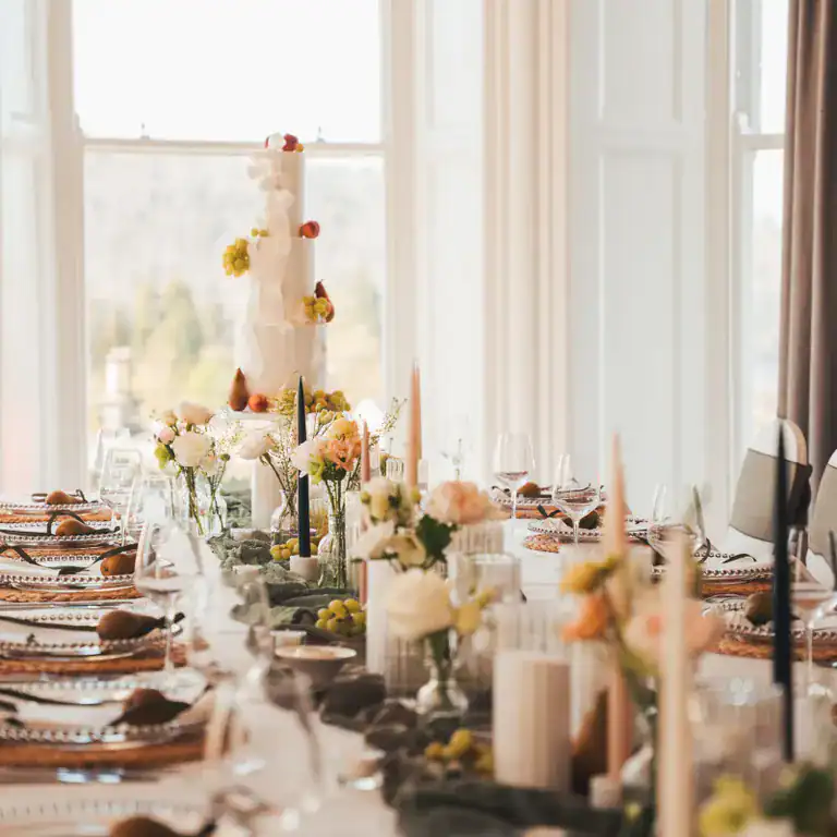 Elegant wedding reception table setup at The Ro Hotel with floral arrangements and candles.