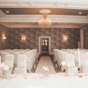 Elegant hotel event space with chandelier and floral decor at The Ro Hotel.