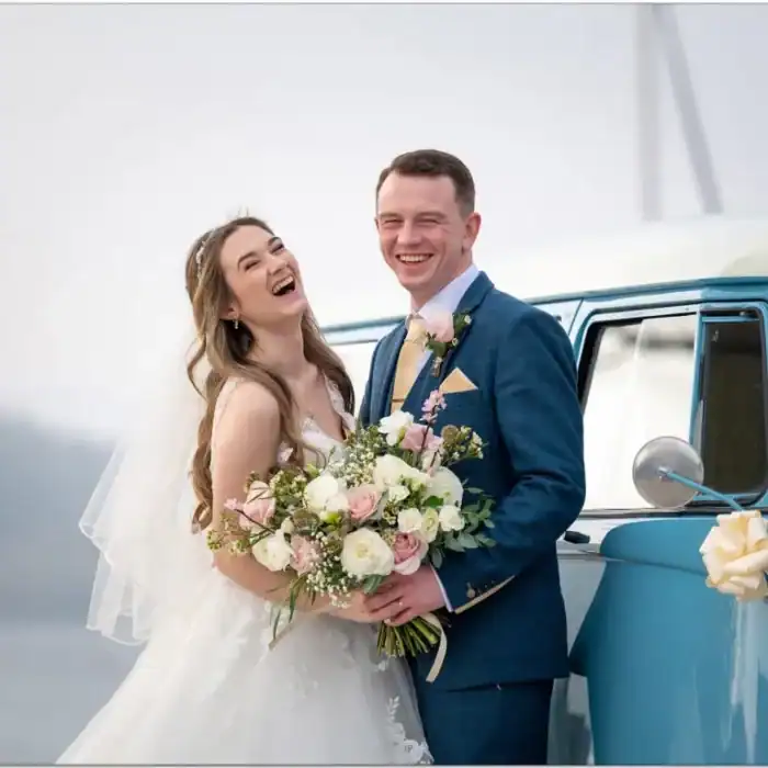 Joyful newlyweds with a bouquet, celebrating their wedding at The Ro Hotel.