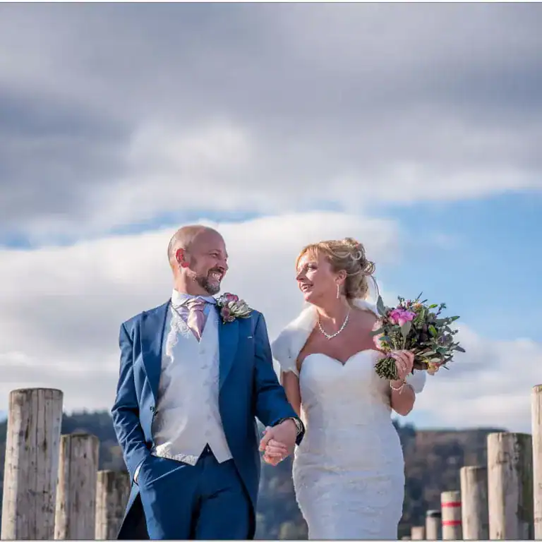 Elegant wedding couple walking outdoors at The Ro Hotel, showcasing a scenic outdoor wedding venue.