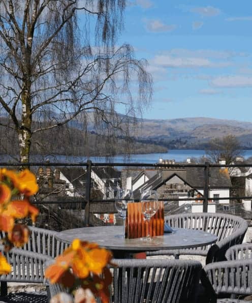 Relaxing outdoor dining with scenic lakeside views at The Ro Hotel in Scotland.
