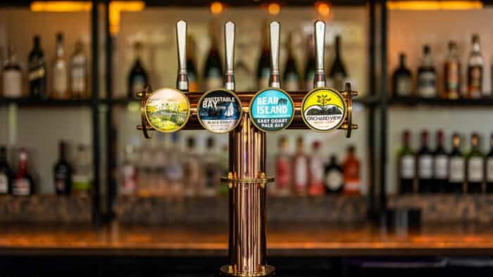Vibrant craft beer taps at The Ro Hotel bar, showcasing a variety of local and international beers.