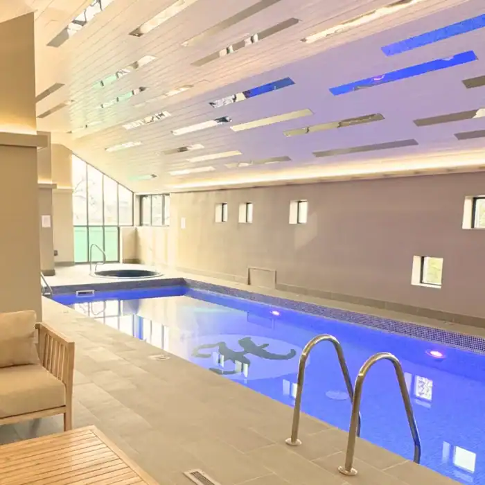 Indoor hotel pool with relaxing ambiance and modern design at The Ro Hotel.