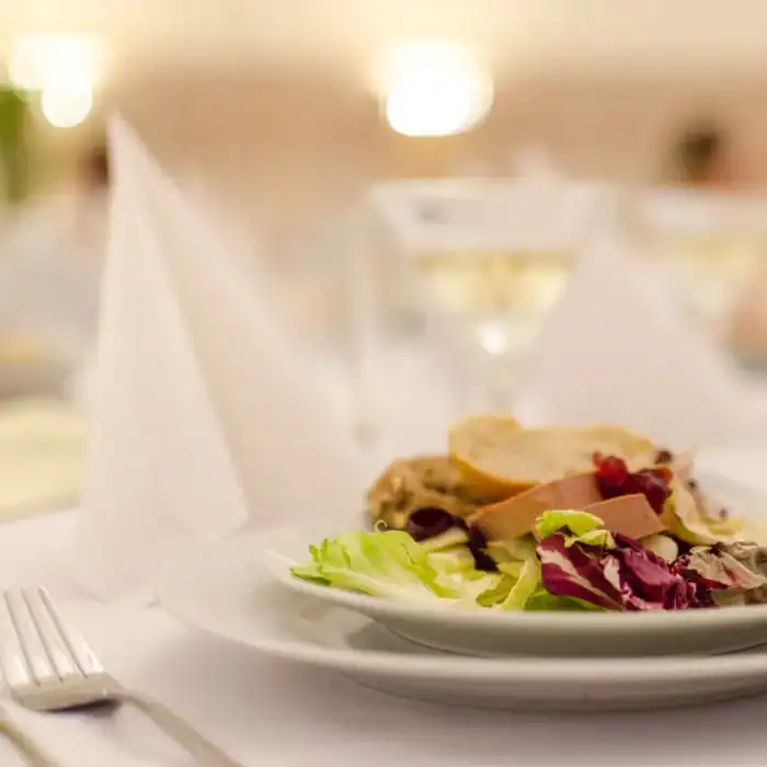 Elegant hotel restaurant with gourmet salads and fine dining ambiance.