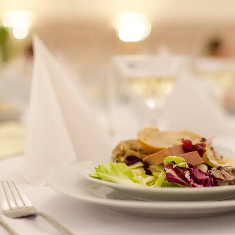 Elegant hotel restaurant with gourmet salads and fine dining ambiance.