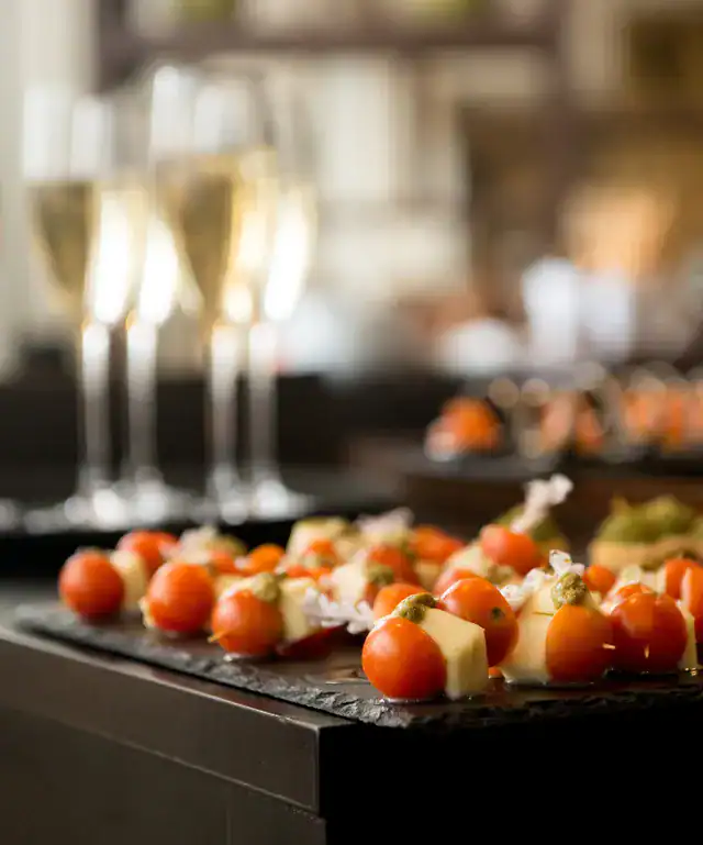 Delicious caprese skewers with cherry tomatoes, mozzarella, and basil at The Ro Hotel.
