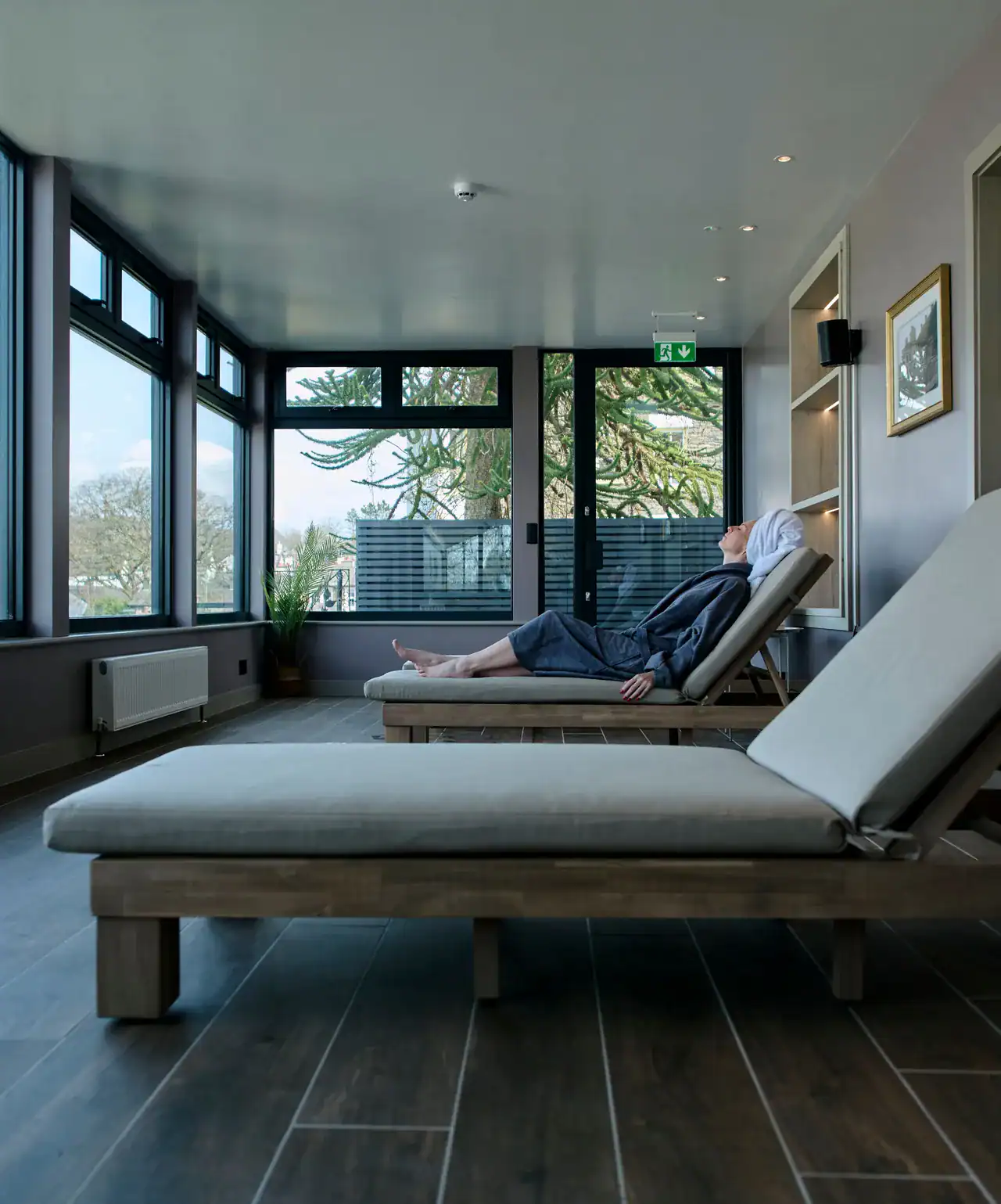 Relaxing spa lounge at The Ro Hotel with comfortable recliners and natural light.