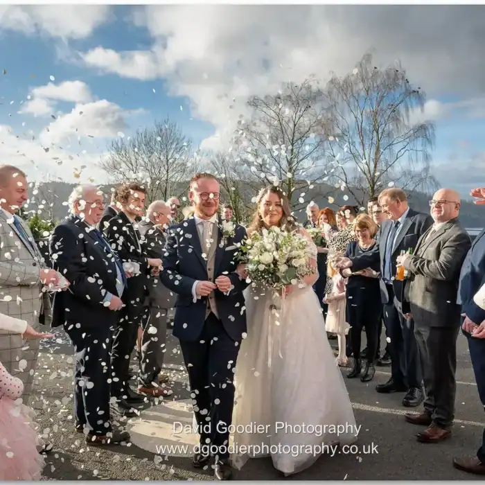 Elegant wedding celebration at The Ro Hotel with confetti, joyful guests, and scenic outdoor setting.